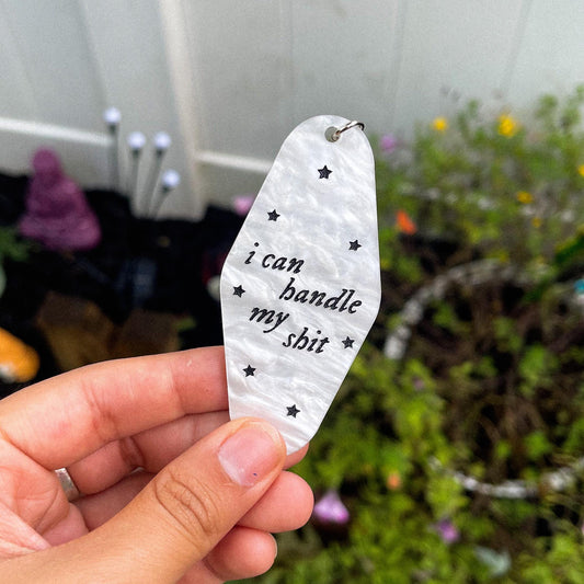 Aesthetic marble motel keychain engraved with the lyrics "I can handle my shit" inspired by Taylor Swift's song I Can Do It With a Broken Heart" 