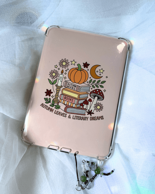 A kindle insert featuring an autumn-themed illustration of books, a pumpkin, mushrooms, stars, etc., and the text 'AUTUMN LEAVES & LITERARY DREAMS'. 