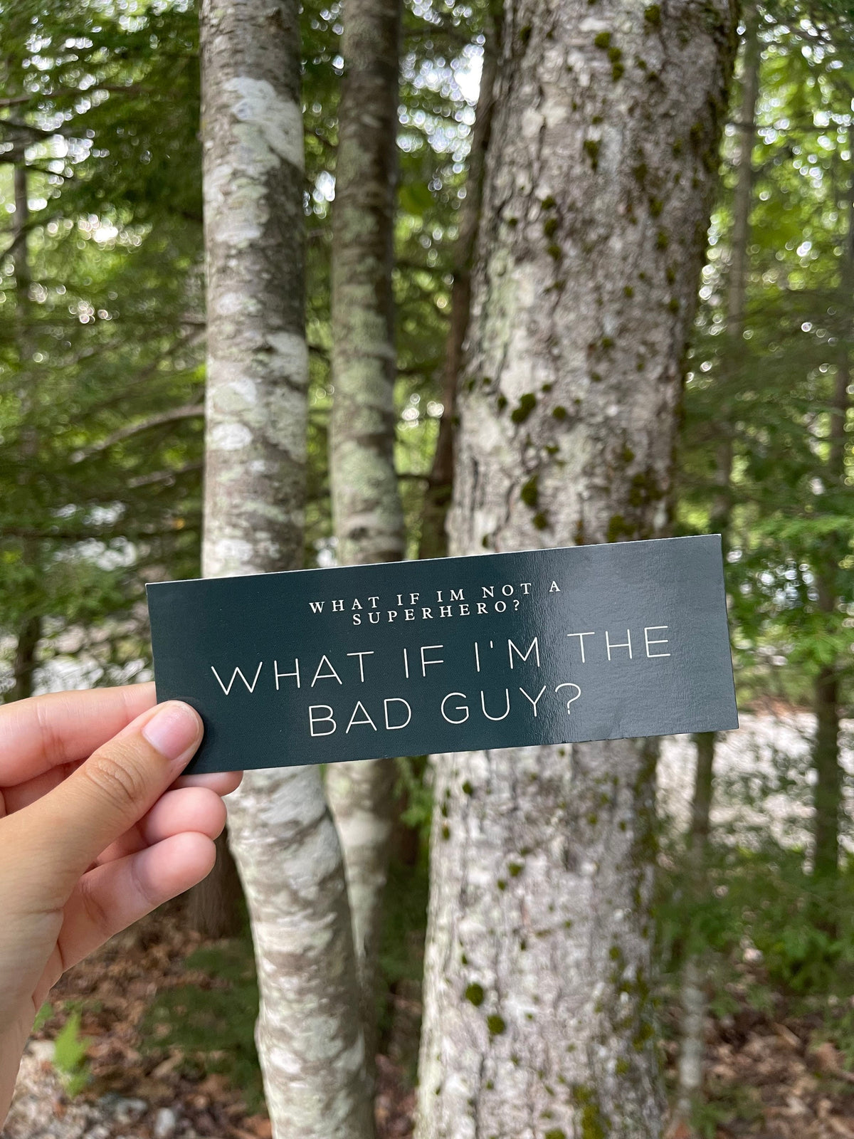 Dark green bookmark with the quote "What if i'm not a superhero? What if i'm the bad guy?"