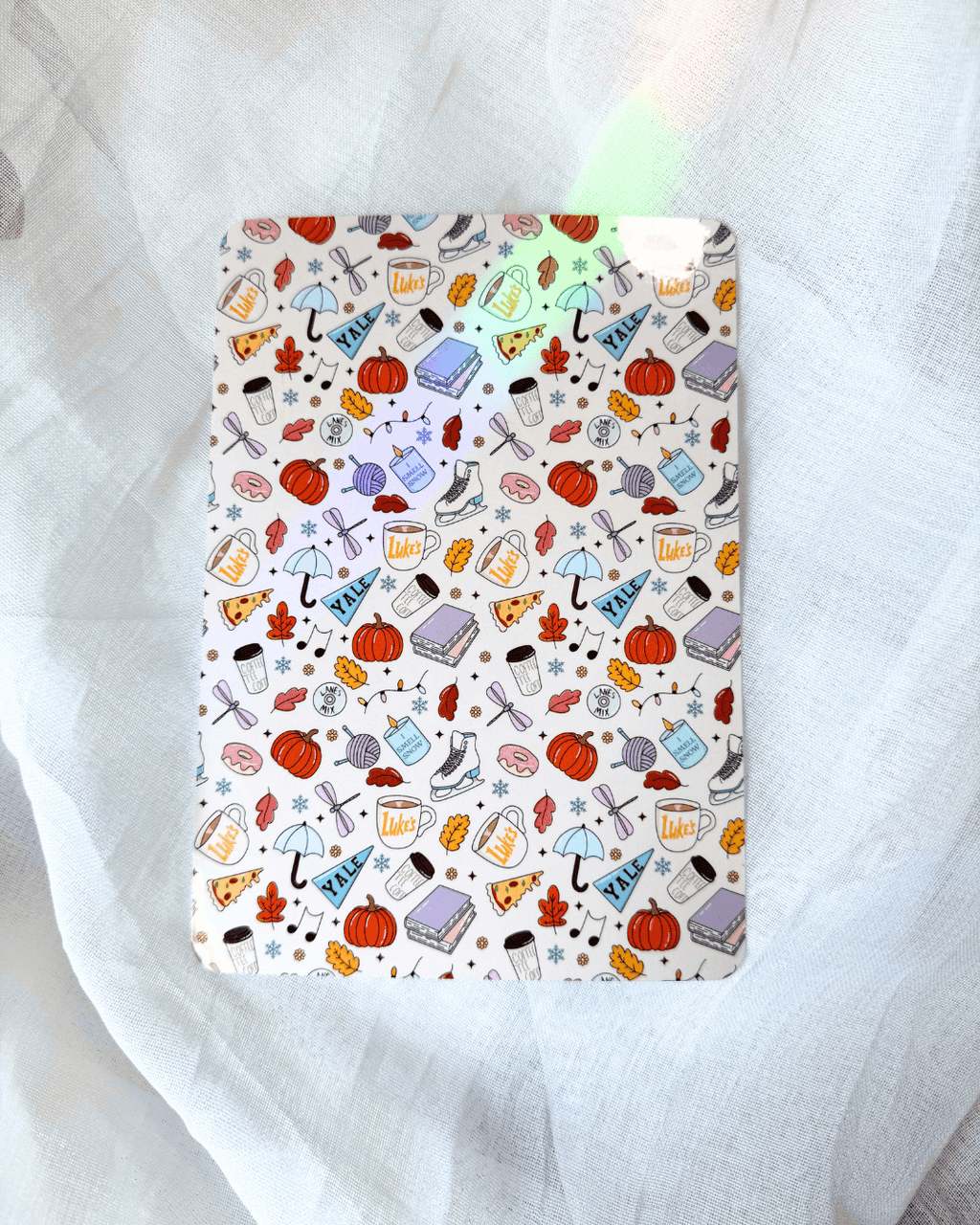 kindle insert with a patterned collage of random illustrations inspired by gilmore girls.