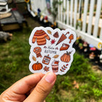 A sticker with a fall-themed design, including the text 'Hello Autumn' and various autumn-related illustrations such as pumpkins, leaves, and pumpkin spice sweets.