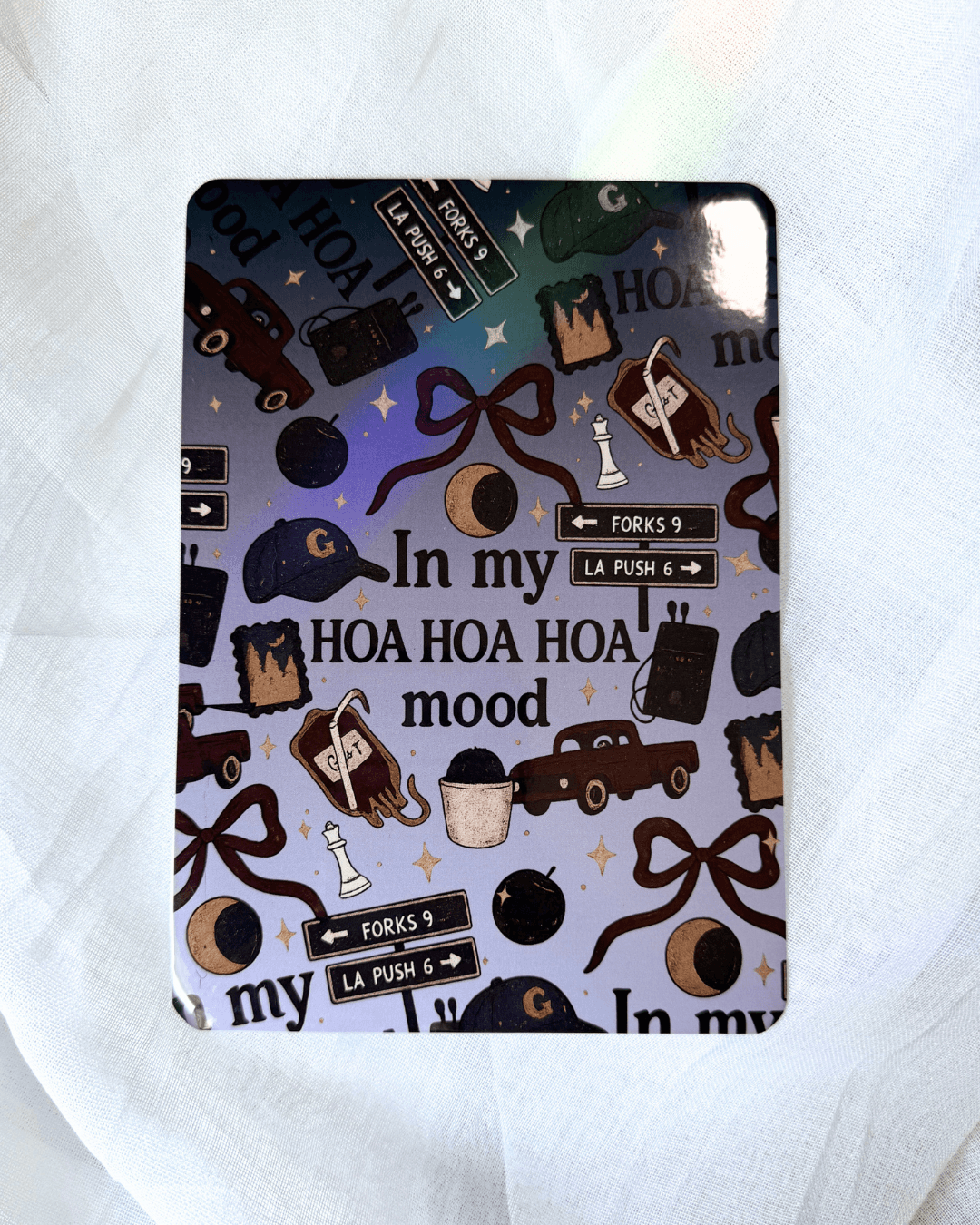A kindle insert inside a case. The insert is inspired by twilight, with the quote "in my hoa hoa hoa mood surrounded by different twilight icons.