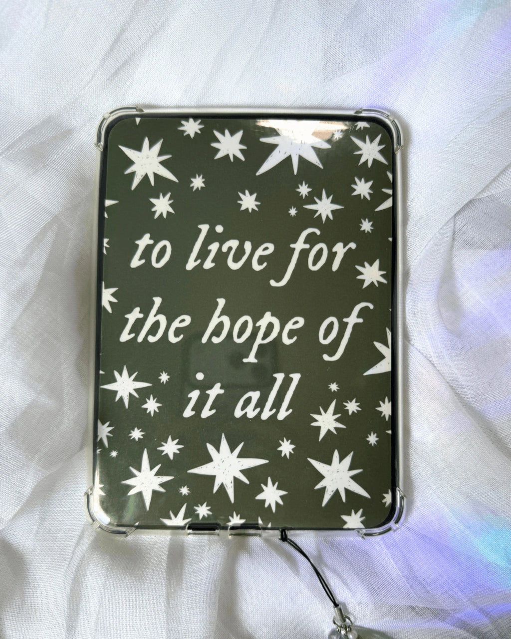 A green kindle insert with the quote "to live for the hope of it all" surrounded by stars.