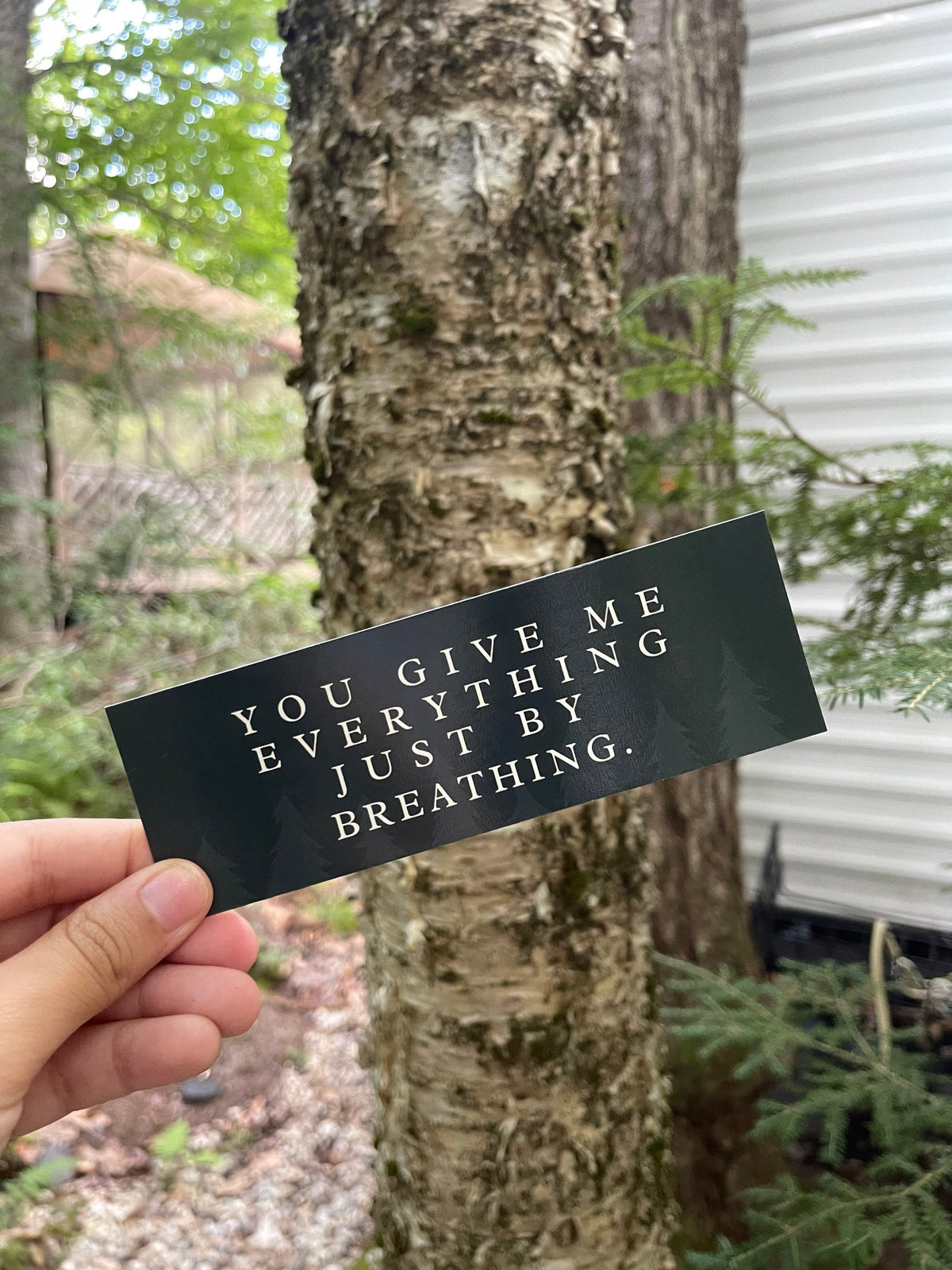 Dark green bookmark with the quote "you give me everything just by breathing."
