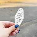 A white marble acrylic motel chain engraved with black sparkles and the text "Who's afraid of little old me."