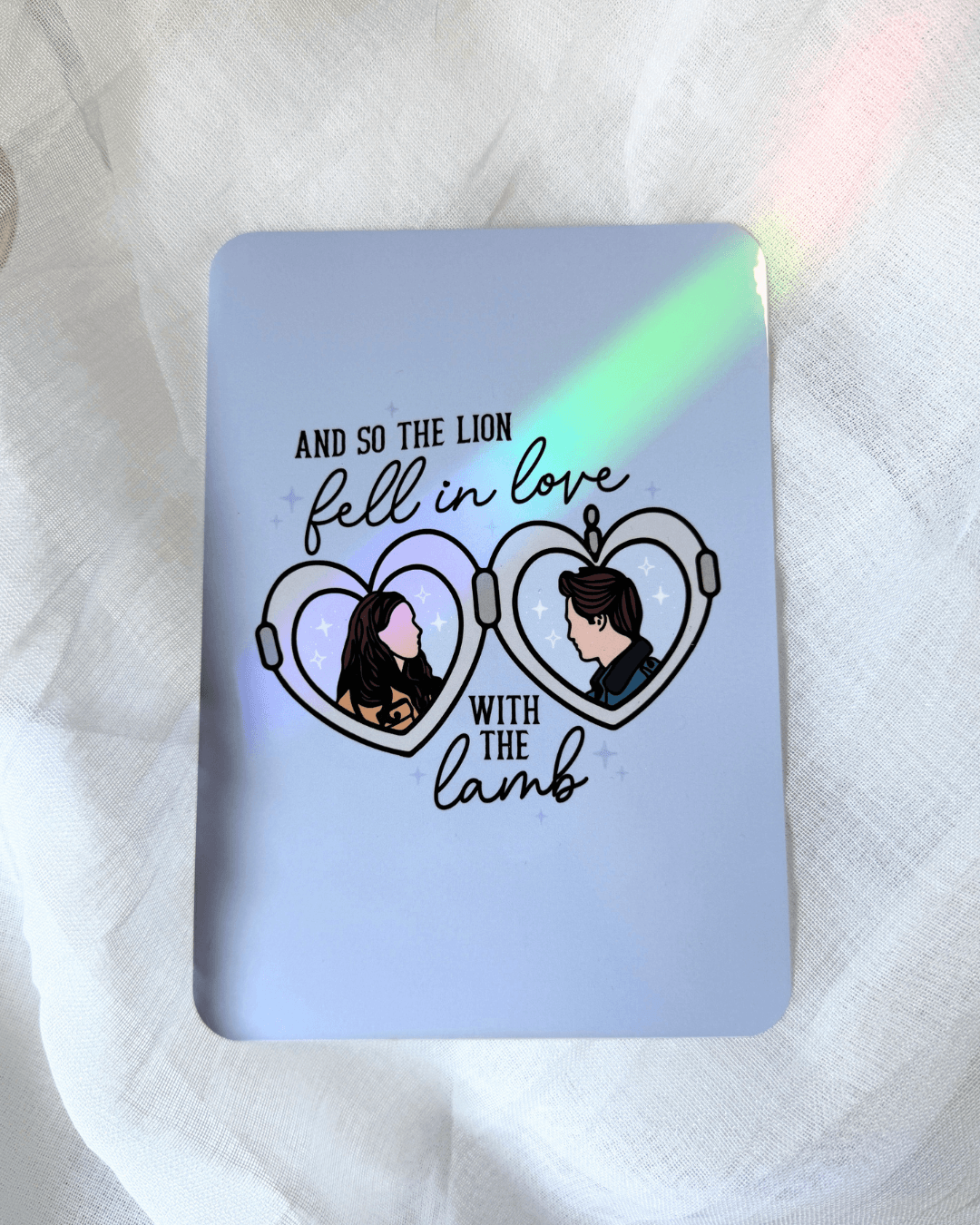 light blue kindle insert with a twilight locket illustration, with the quote "and so the lion fell in love with the lamb."