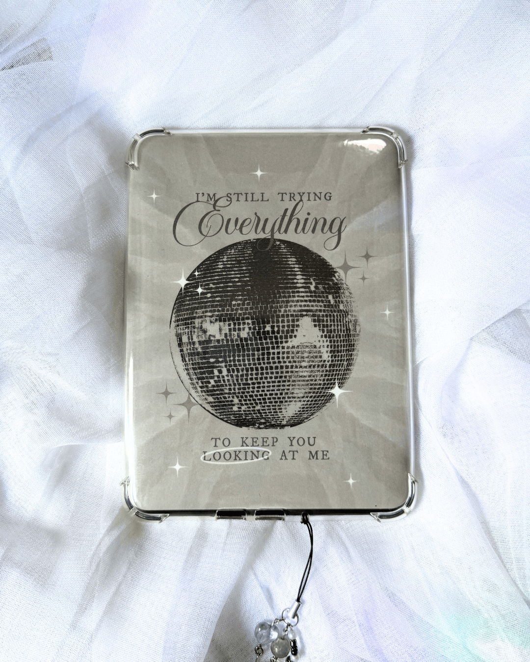 Grayish kindle insert with a large mirrorball and the quote "i'm still trying everything to keep you looking at me."