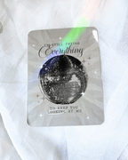 Grayish kindle insert with a large mirrorball and the quote "i'm still trying everything to keep you looking at me."
