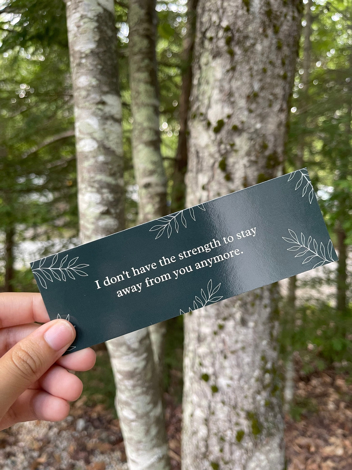 Green bookmark with the quote "i don't have the strength to stay away fro you anymore."