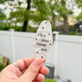 A white marble acrylic motel chain engraved with black stars and the text "I'm a real tough kid."