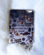 A kindle insert inside a case. The insert is inspired by twilight, with the quote "in my hoa hoa hoa mood surrounded by different twilight icons.