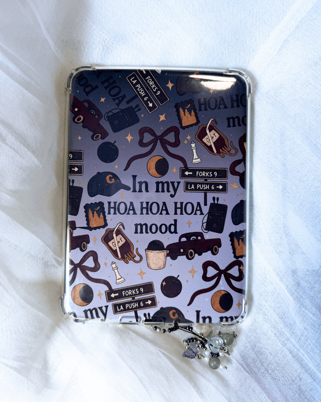A kindle insert inside a case. The insert is inspired by twilight, with the quote "in my hoa hoa hoa mood surrounded by different twilight icons.