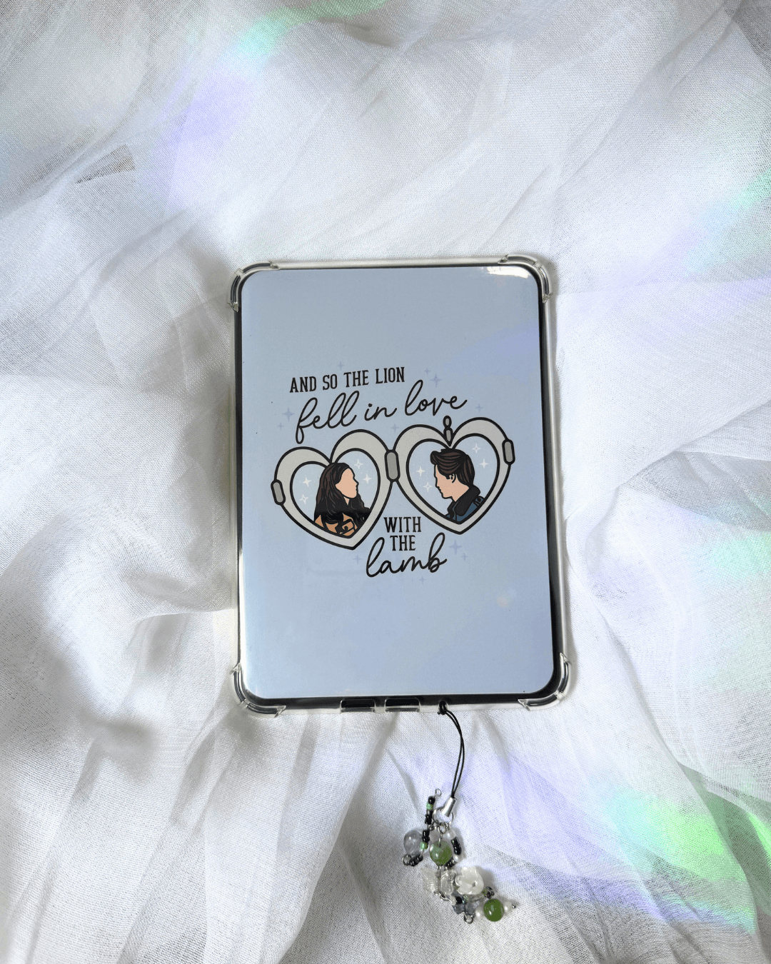 light blue kindle insert with a twilight locket illustration, with the quote "and so the lion fell in love with the lamb."