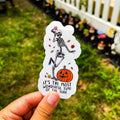 A sticker with a skeleton character, pumpkin, and autumn leaves with the text 'It's the most wonderful time of the year'.